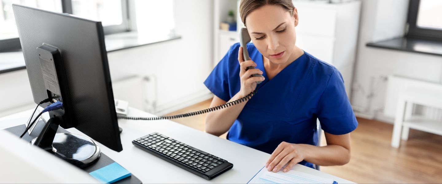 Woman on the phone and reading paperwork
